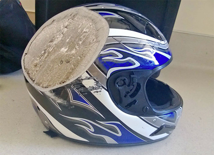 A helmet is damaged at the top